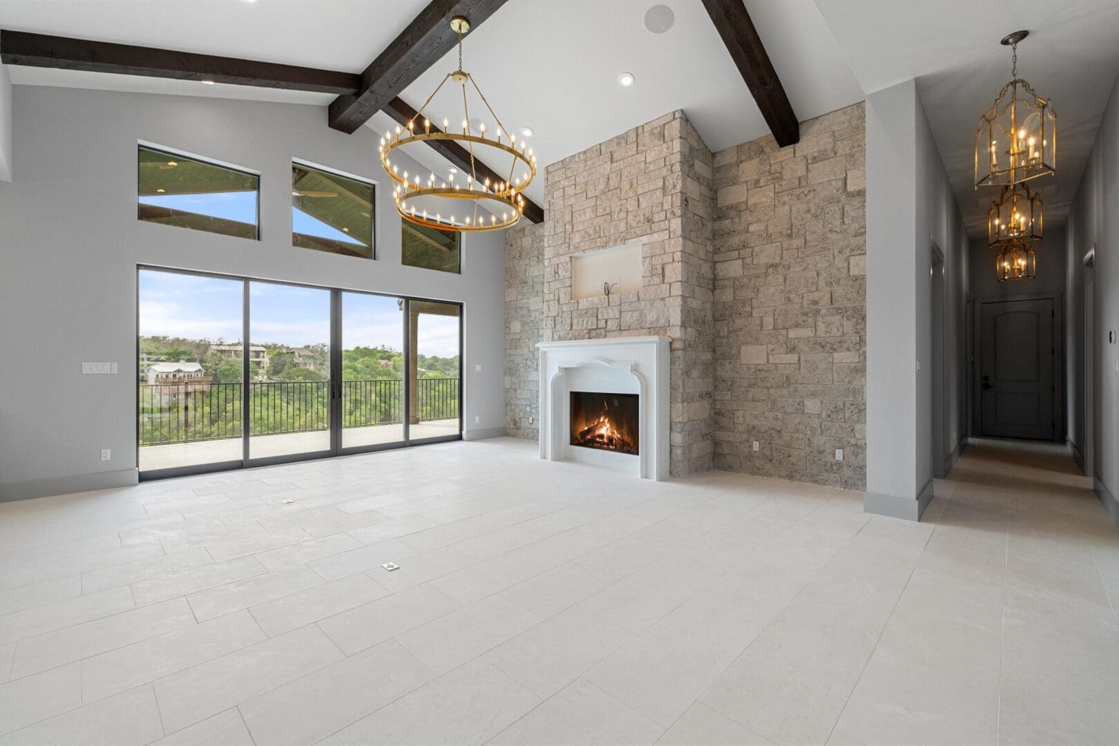 Spacious living room with large windows and modern fireplace.