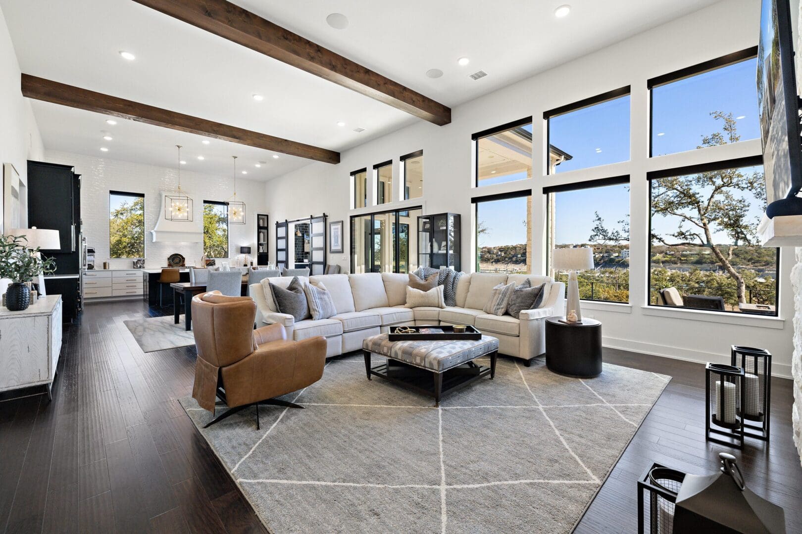 Spacious modern living room with large windows and cozy seating.