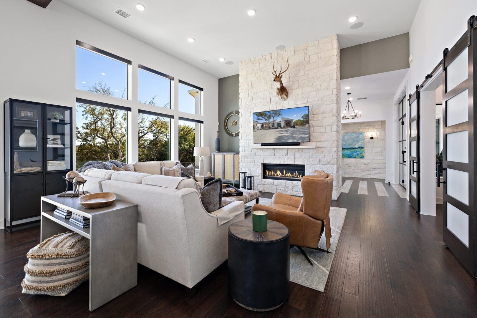 Modern living room with large windows and cozy seating.
