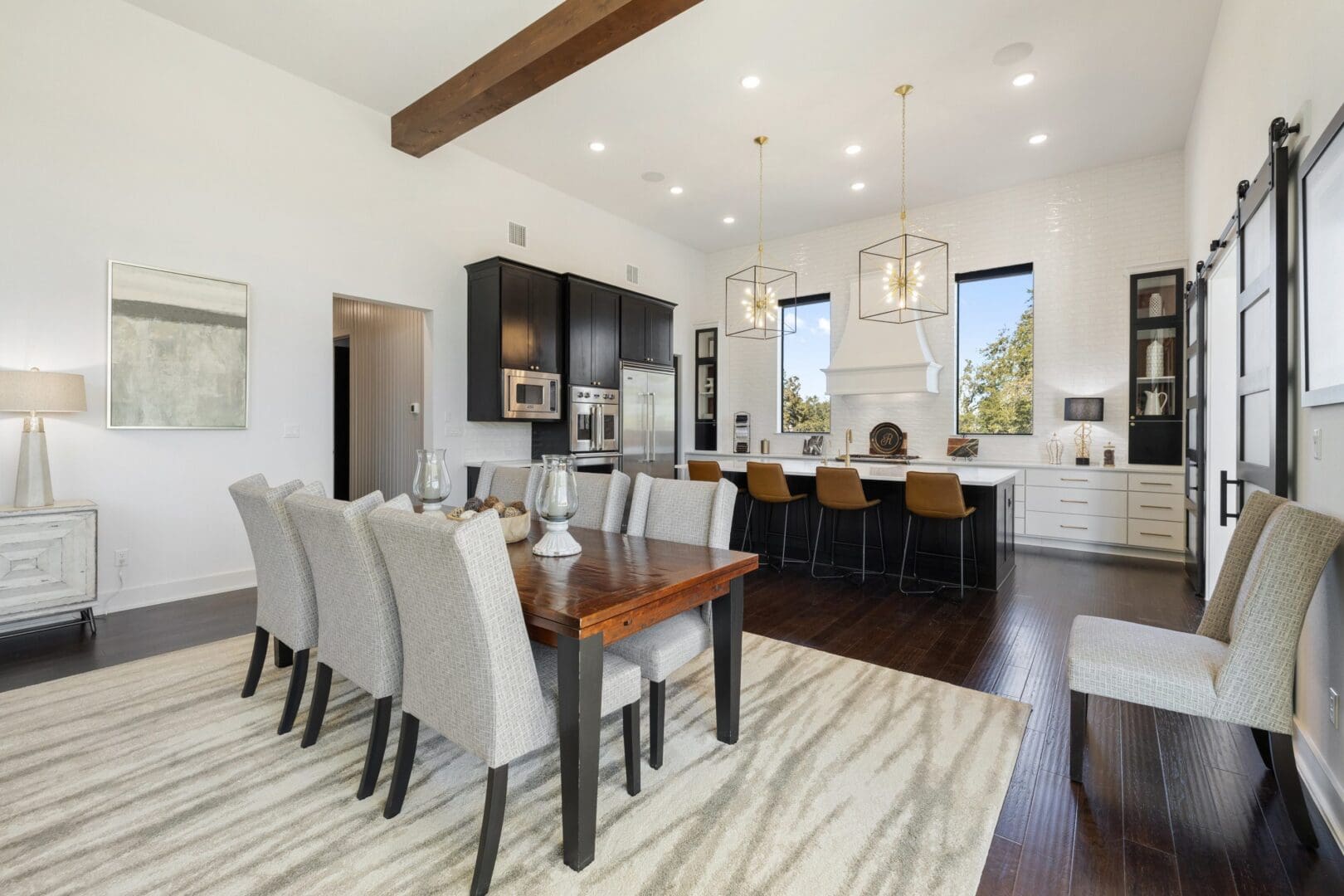 Modern kitchen and dining area with elegant furnishings and ample seating.