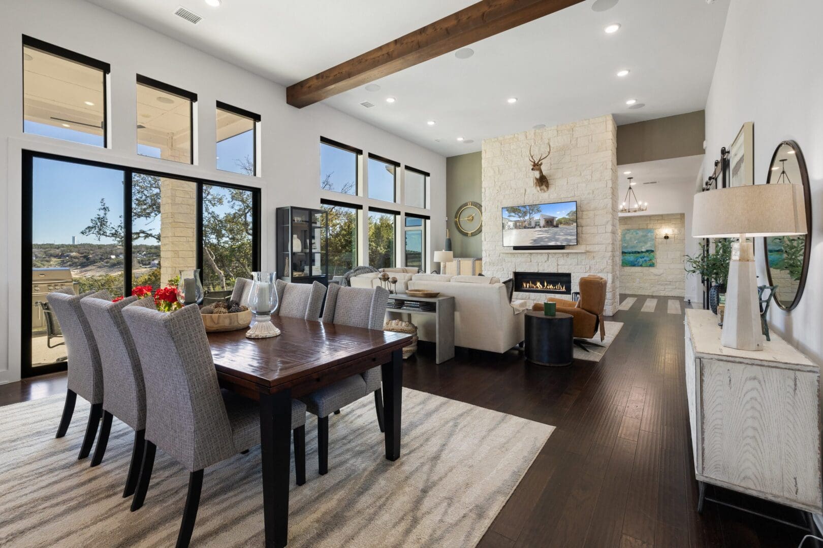 Bright open-concept living and dining area with modern decor and large windows.