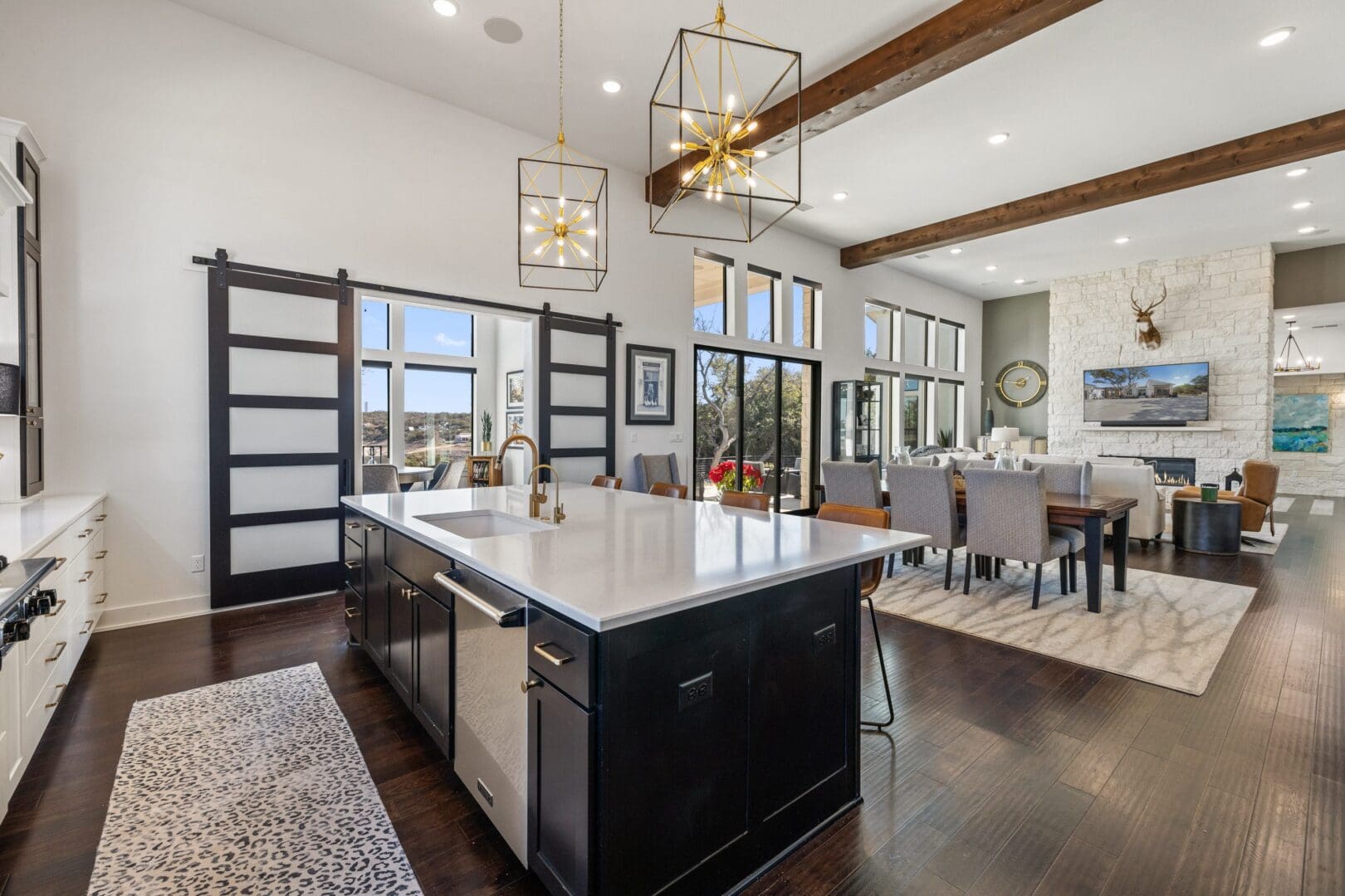 Spacious kitchen with a large island and elegant lighting fixtures.