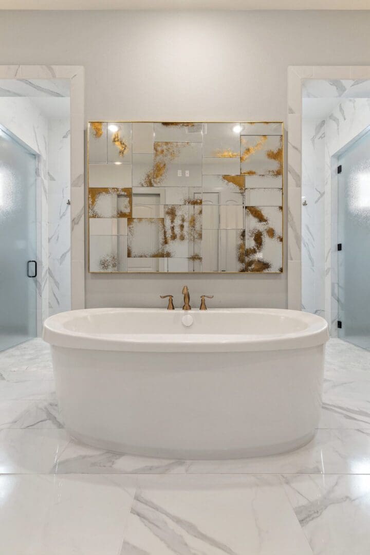 Elegant white bathroom with a freestanding tub and gold accents.
