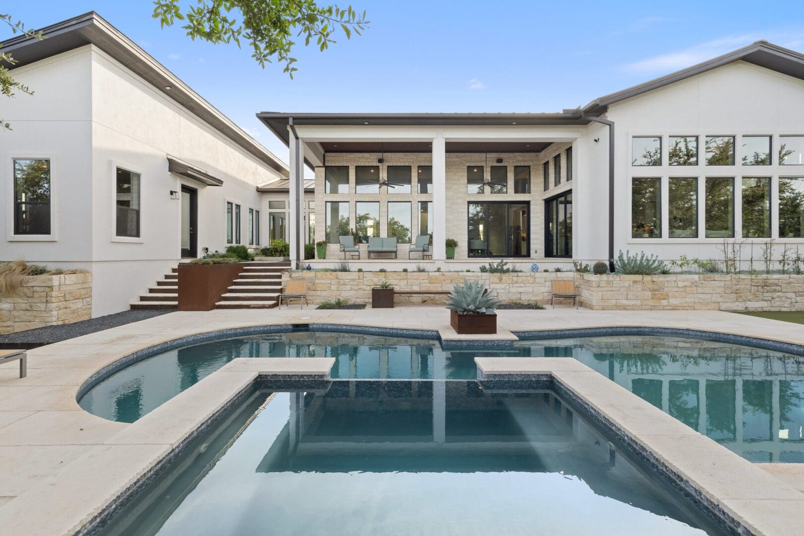 Modern house with a spacious patio and pool.
