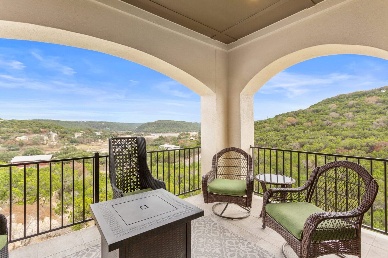 Cozy balcony with chairs and scenic mountain view.