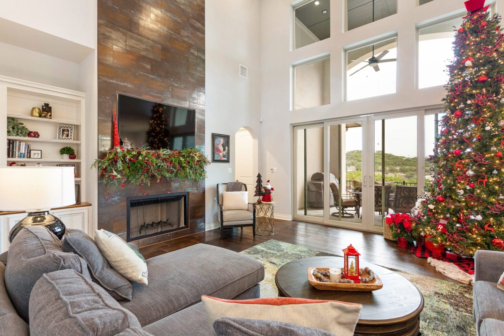 Cozy living room with fireplace and large windows overlooking a scenic view.
