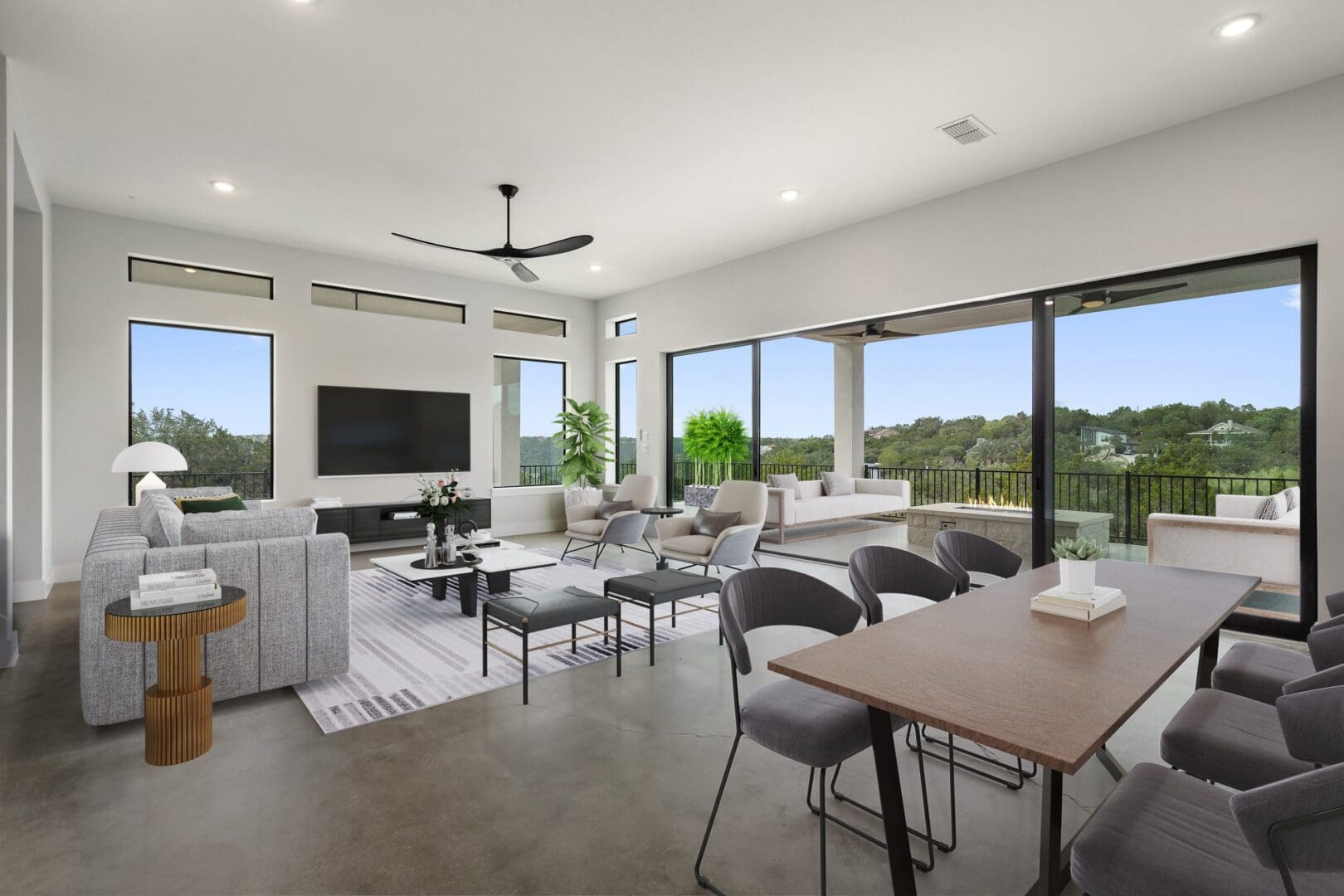 Spacious modern living room with large windows and elegant furniture.