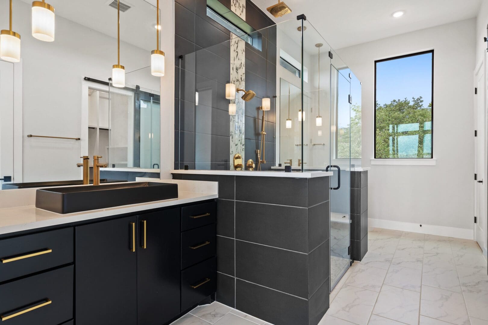 Modern bathroom with black cabinetry and glass shower enclosure.