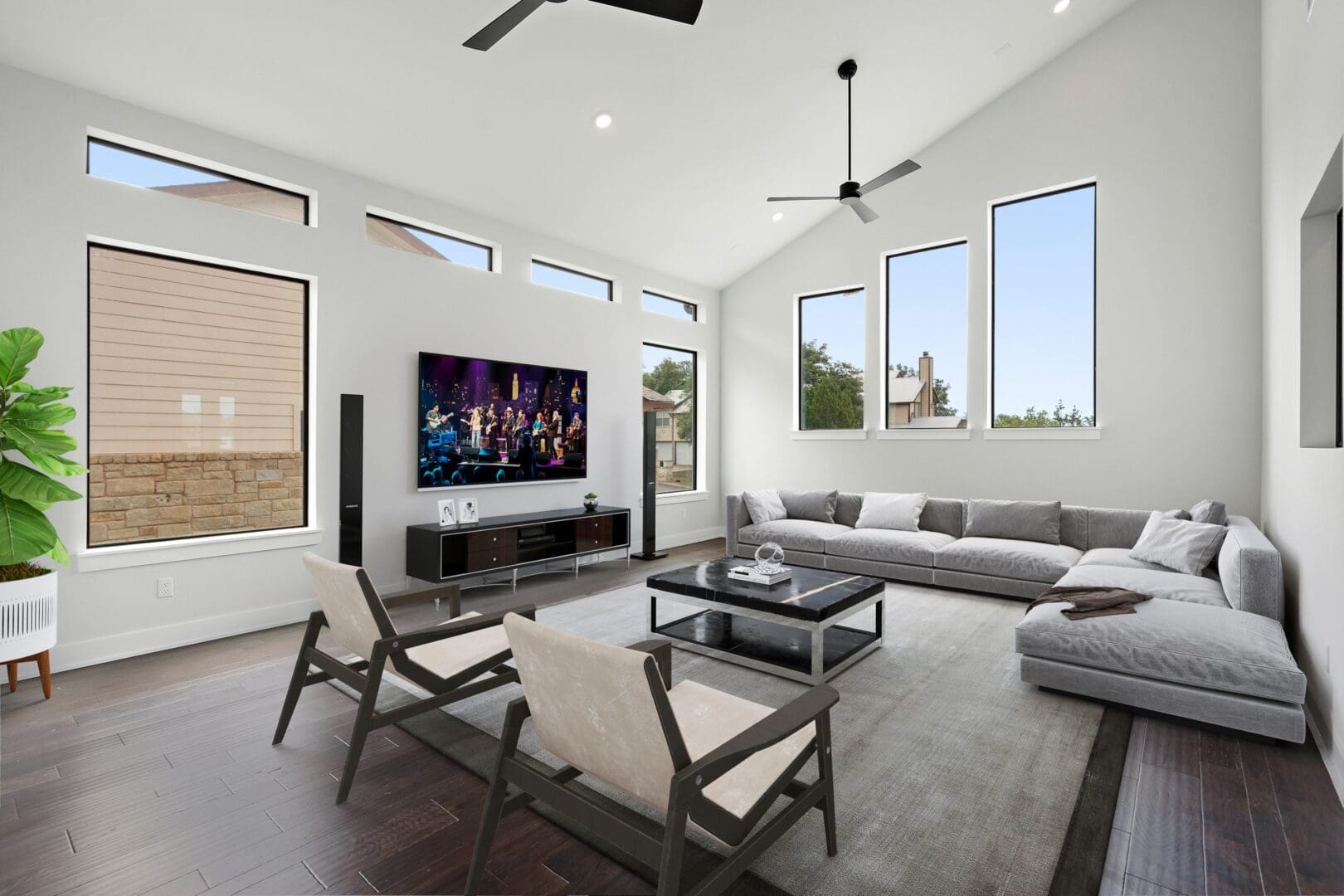Modern living room with gray sectional sofa and large windows.