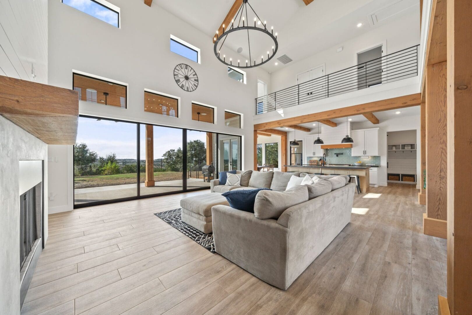 Spacious modern living room with large windows and neutral tones.