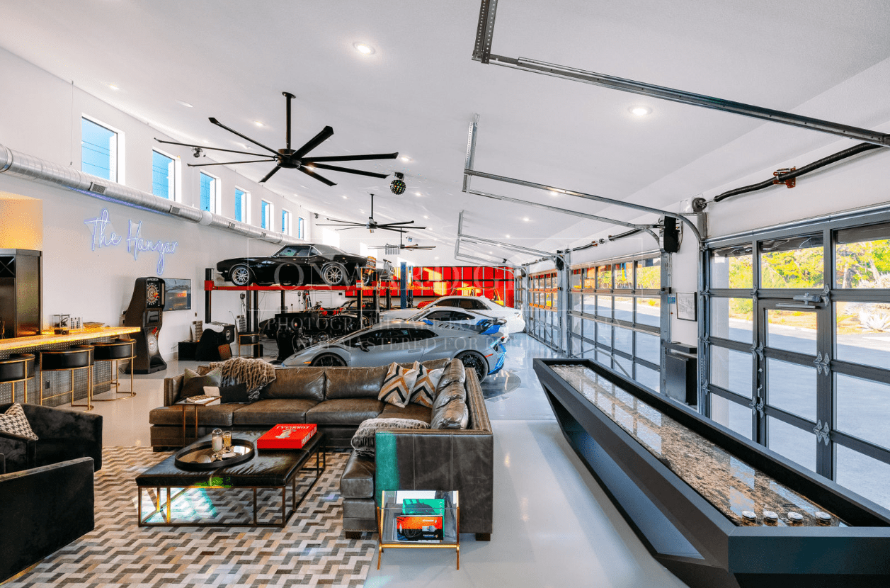 Modern living room with stylish furniture and large windows.
