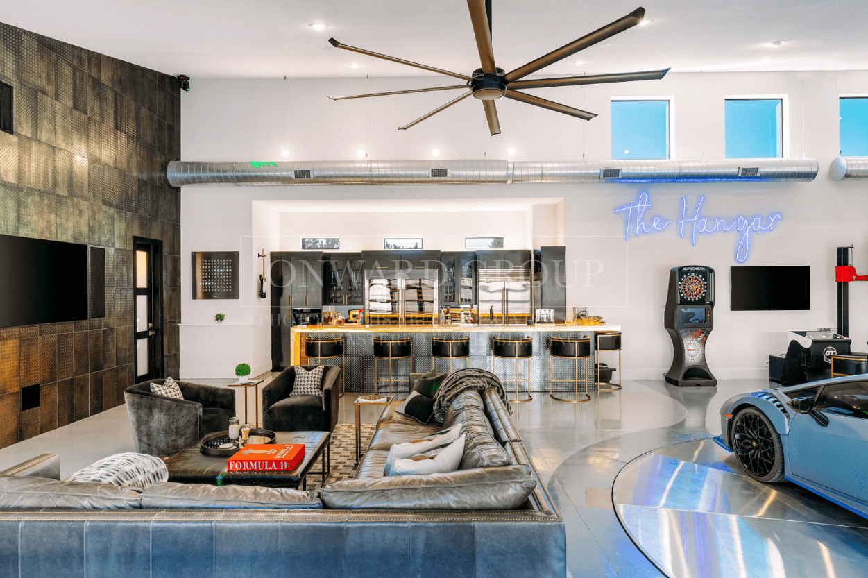 Modern living room with stylish furniture and a ceiling fan.