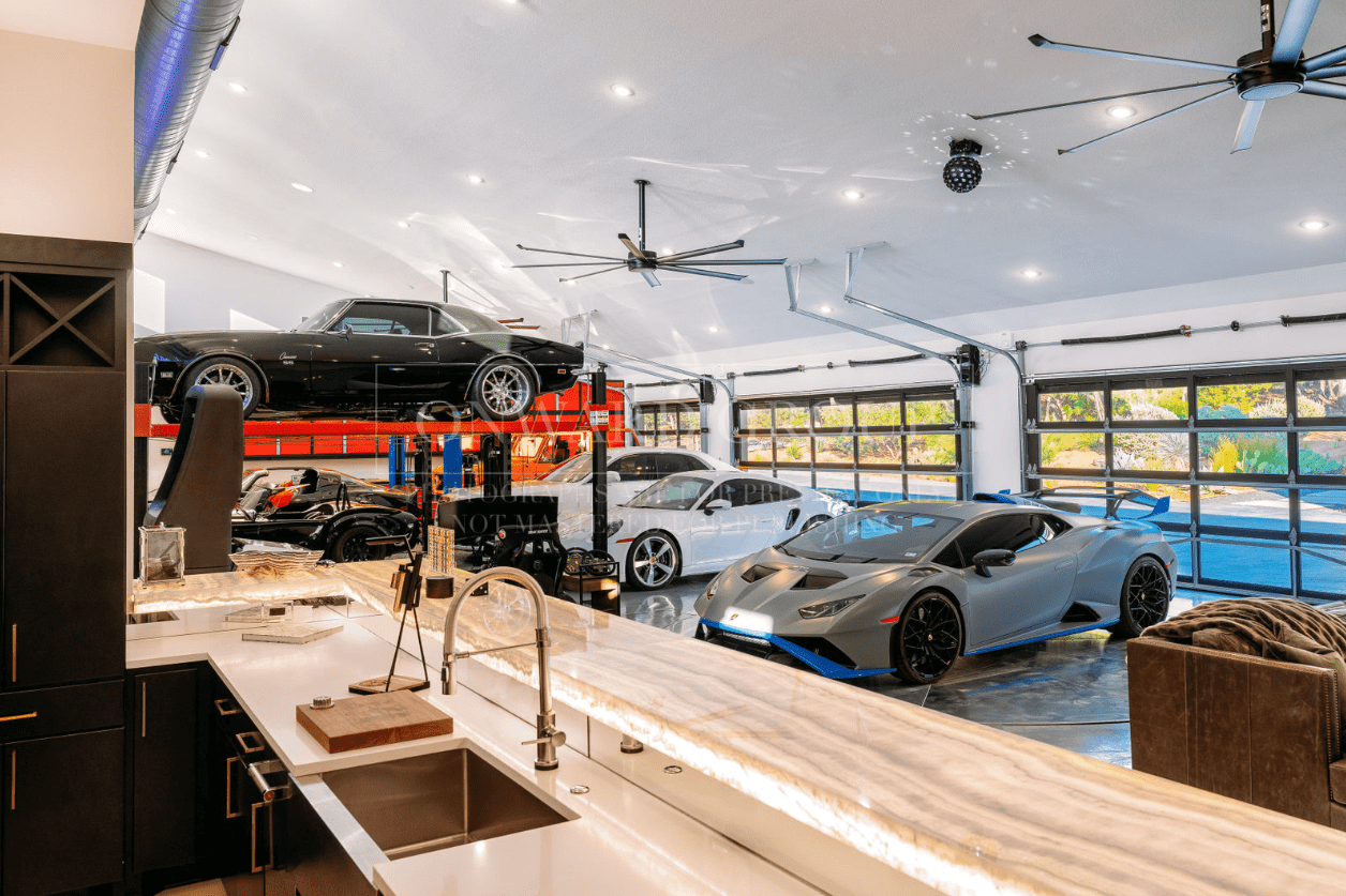 Modern garage with luxury cars and sleek design.