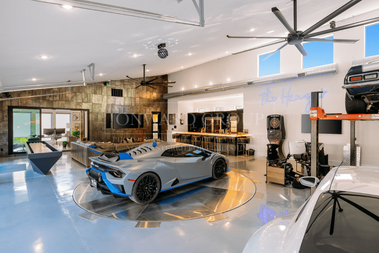A sleek silver sports car displayed in a modern showroom with stylish decor.